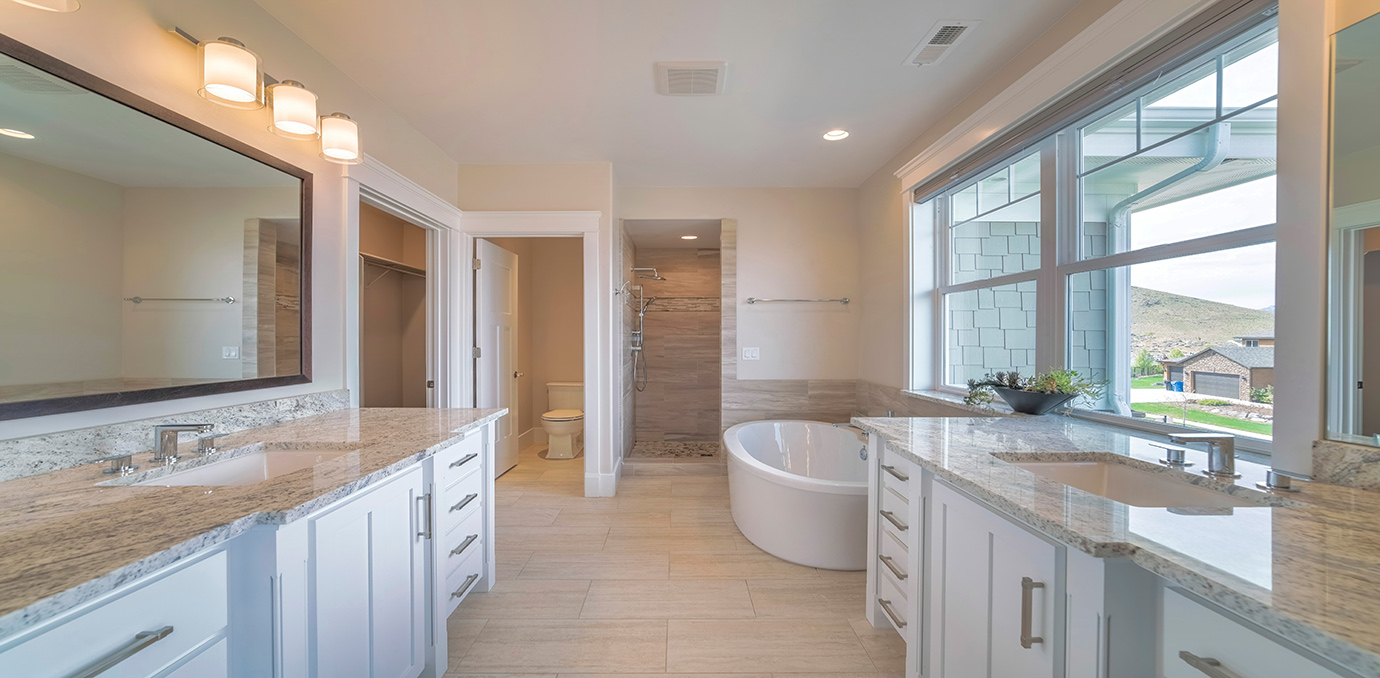 Richly tiled master bathroom of a house with windows